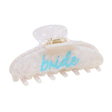 Clear hair clip with 'bride' written on it against a white background. Available at Be Charmed