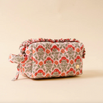 Floral patterned toiletry bag on a beige background. Available at Be Charmed