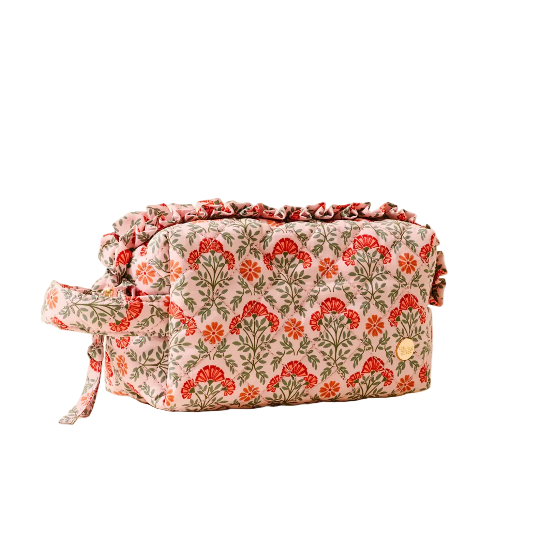 Floral patterned toiletry bag on a beige background. Available at Be Charmed