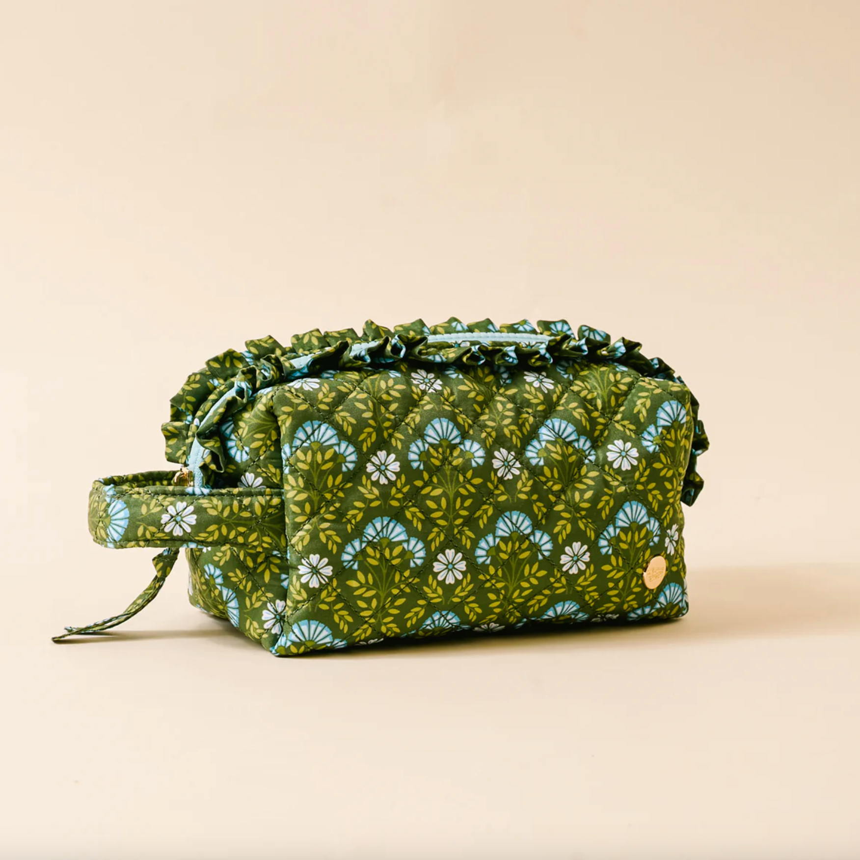 Green floral Everbloom Forest patterned fabric cosmetic bag on a beige background. Available at Be Charmed. 
