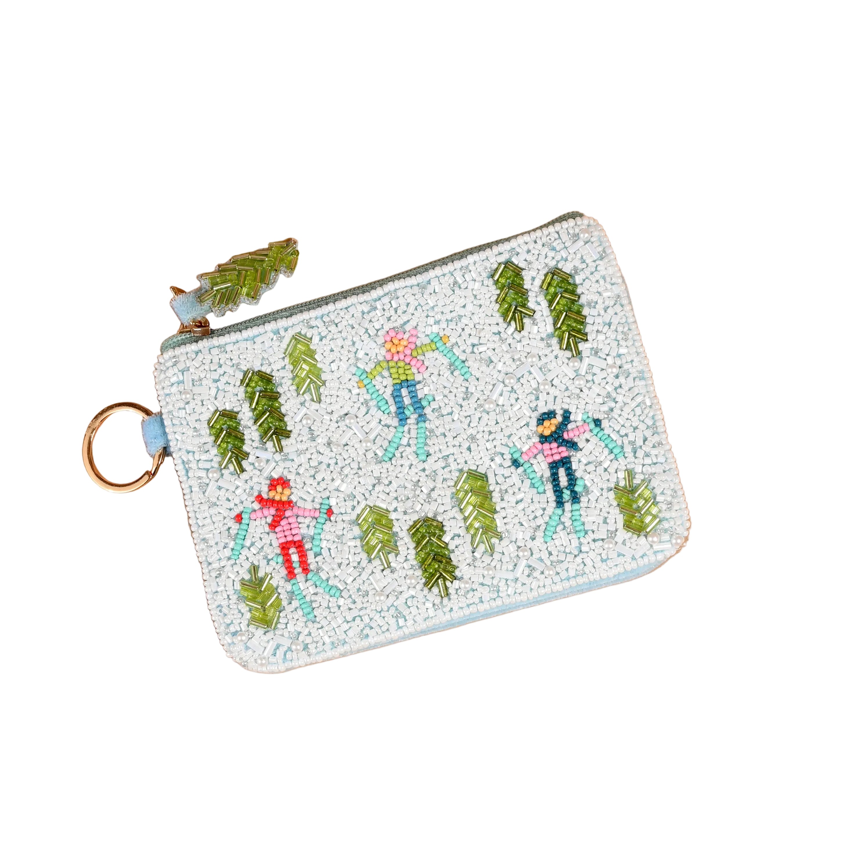 A small zippered Darling Effect pouch with a light blue border and a gold-tone key ring, decorated with embroidered figures and trees in green, pink, blue, and orange on a speckled white fabric. Available at Be Charmed