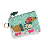 A small zippered Darling Effect pouch decorated with a beaded dachshund wearing a colorful sweater,. Available at Be Charmed