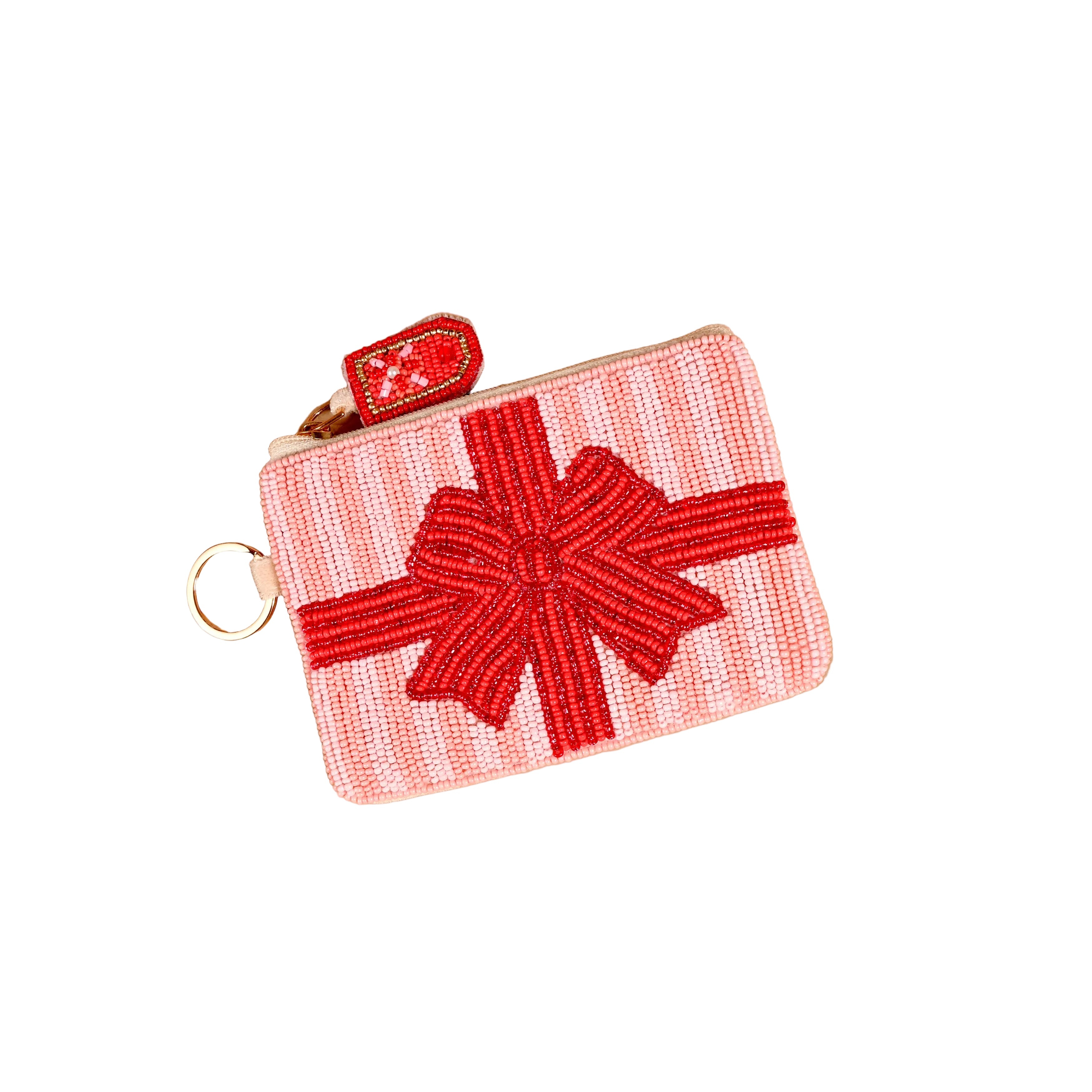 A small zippered Darling Effect pouch designed to look like a wrapped gift box, featuring a pink and white striped body with a red beaded bow on the front, a red pull tab, and a gold-tone key ring. Available at Be Charmed