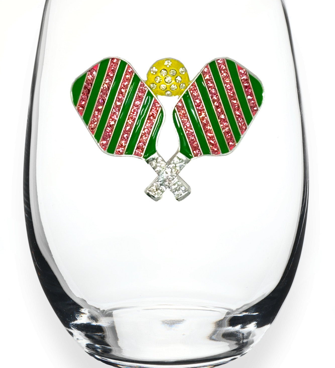 A clear stemless wine glass featuring a decorative front emblem of two crossed pickleball rackets with green and pink striped wings, a yellow textured center, and silver crossed handles, shown on a white background. Available at Be Charmed