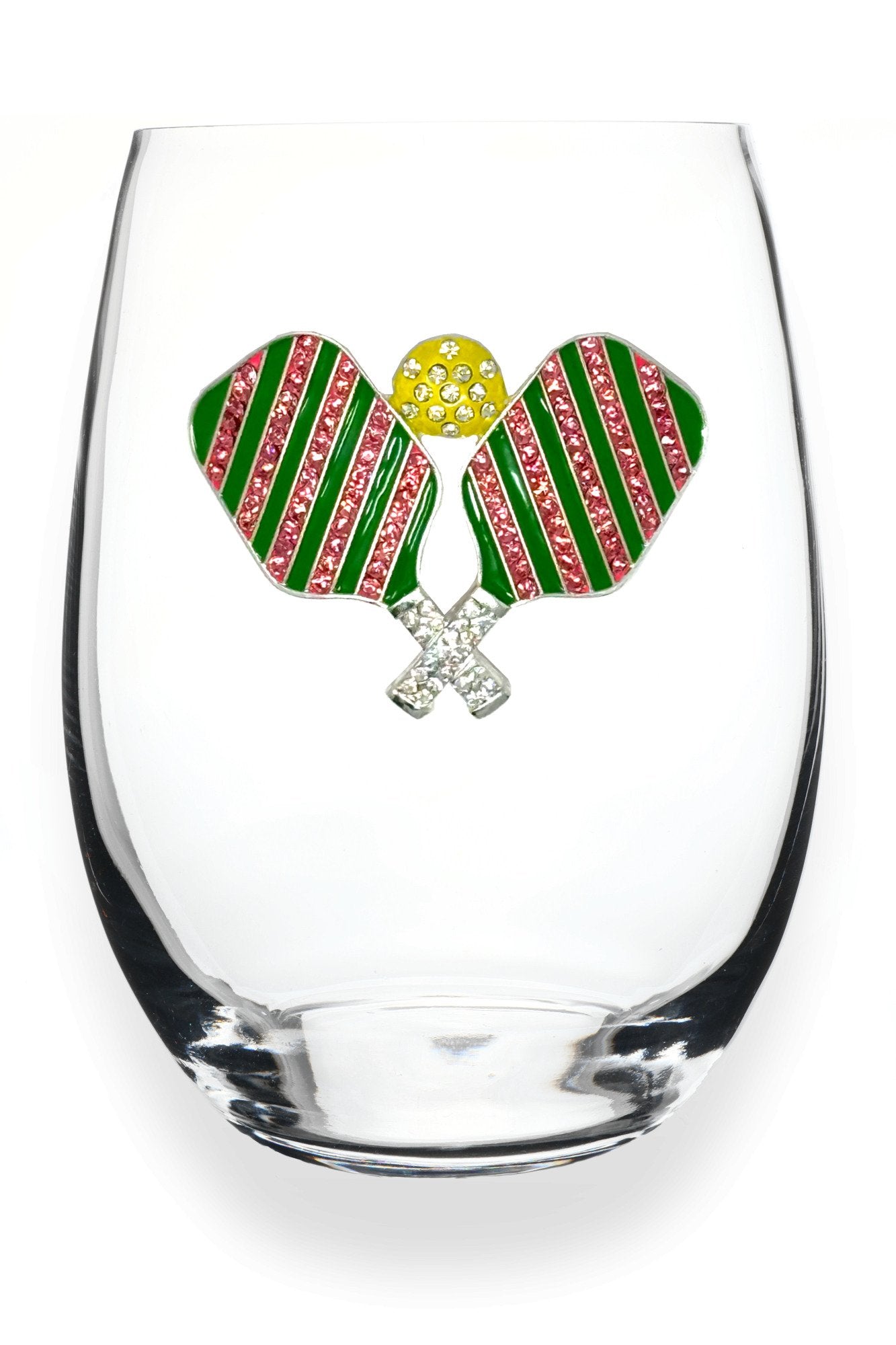 A clear stemless wine glass featuring a decorative front emblem of two crossed pickleball rackets with green and pink striped wings, a yellow textured center, and silver crossed handles, shown on a white background. Available at Be Charmed