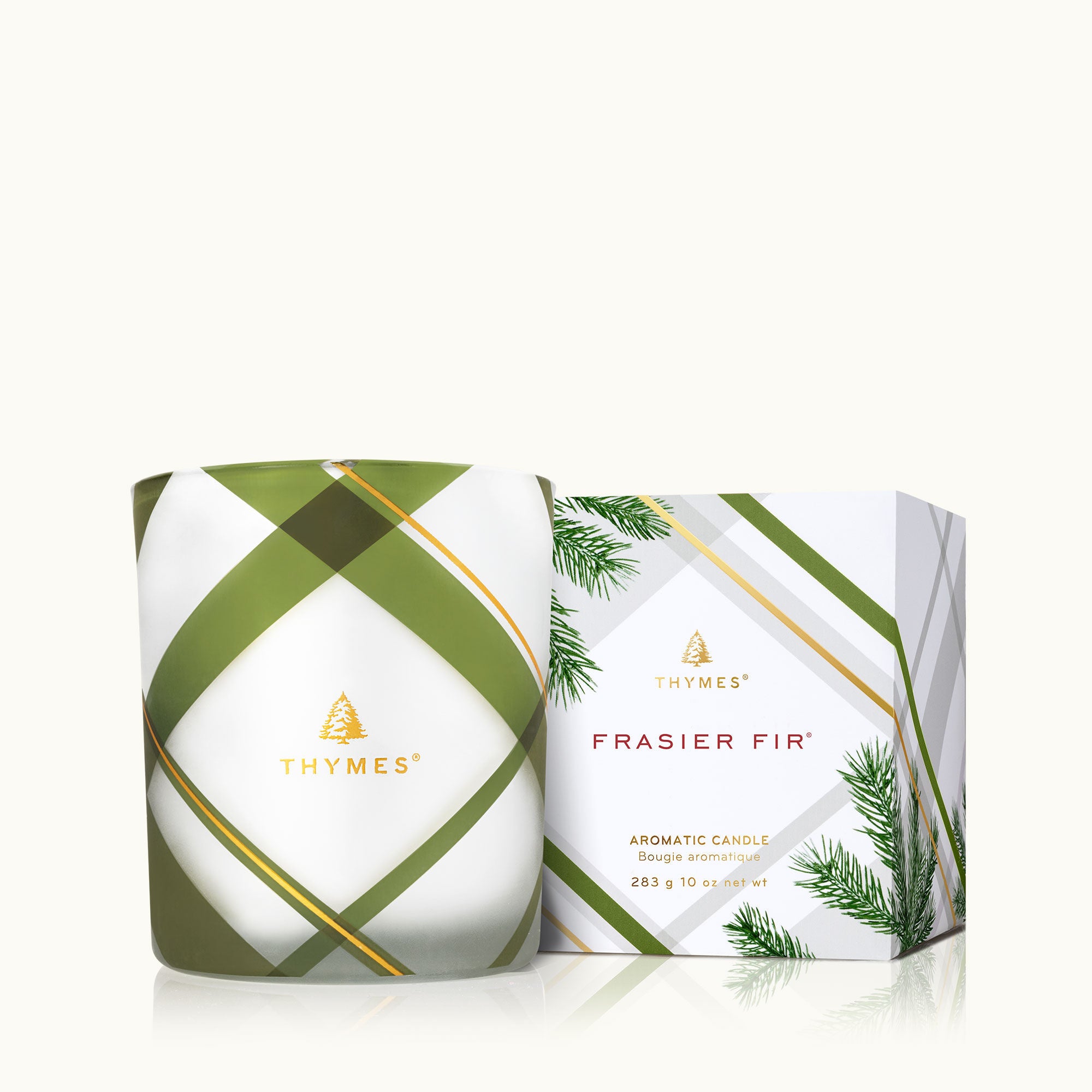 Thymes Frasier Fir Frosted Plaid Medium Candle with festive pine fragrance in a stylish medium candle. Available at Be Charmed.