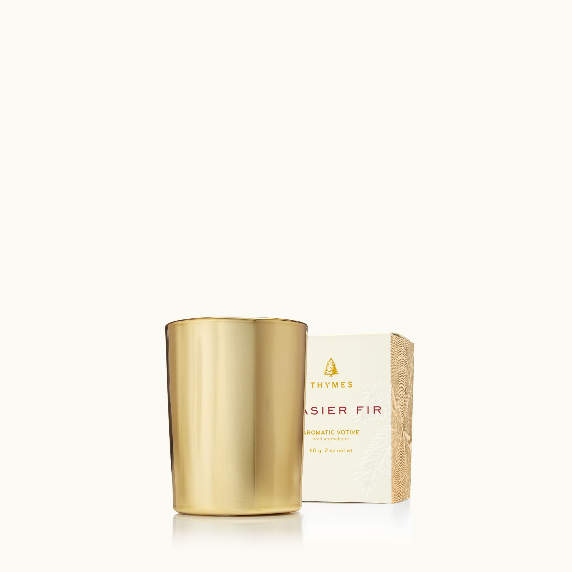 Thymes Frasier Fir Gilded Gold Votive Candle with festive, hand-poured fragrance in elegant gold votive. Available at Be Charmed.