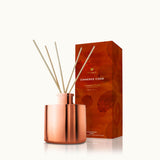Thymes Simmered Cider Petite Reed Diffuser with warm, spiced fragrance for home ambiance. Available at Be Charmed.