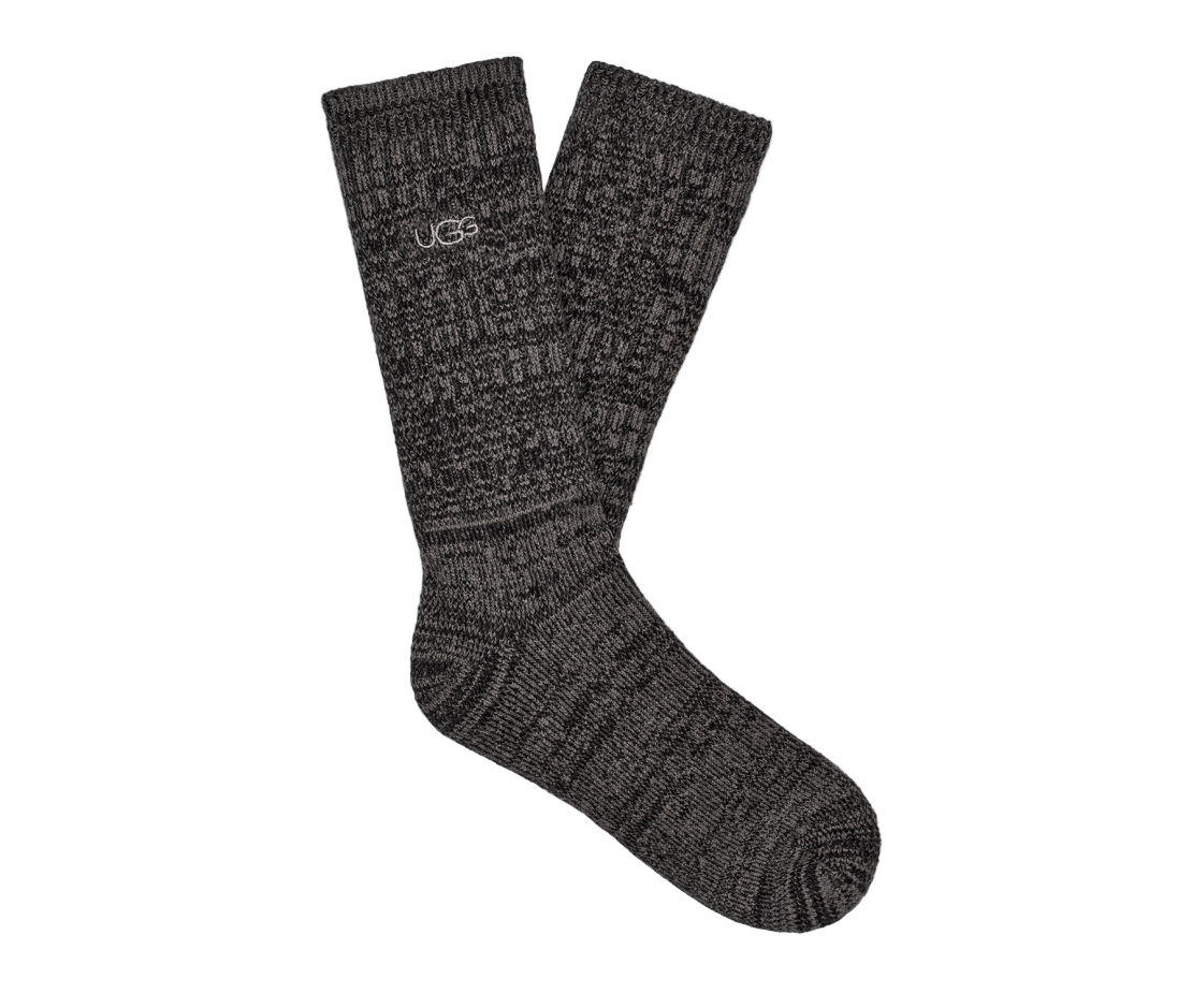 Pair of dark gray socks with a brand logo on a white background. Available at Be Charmed