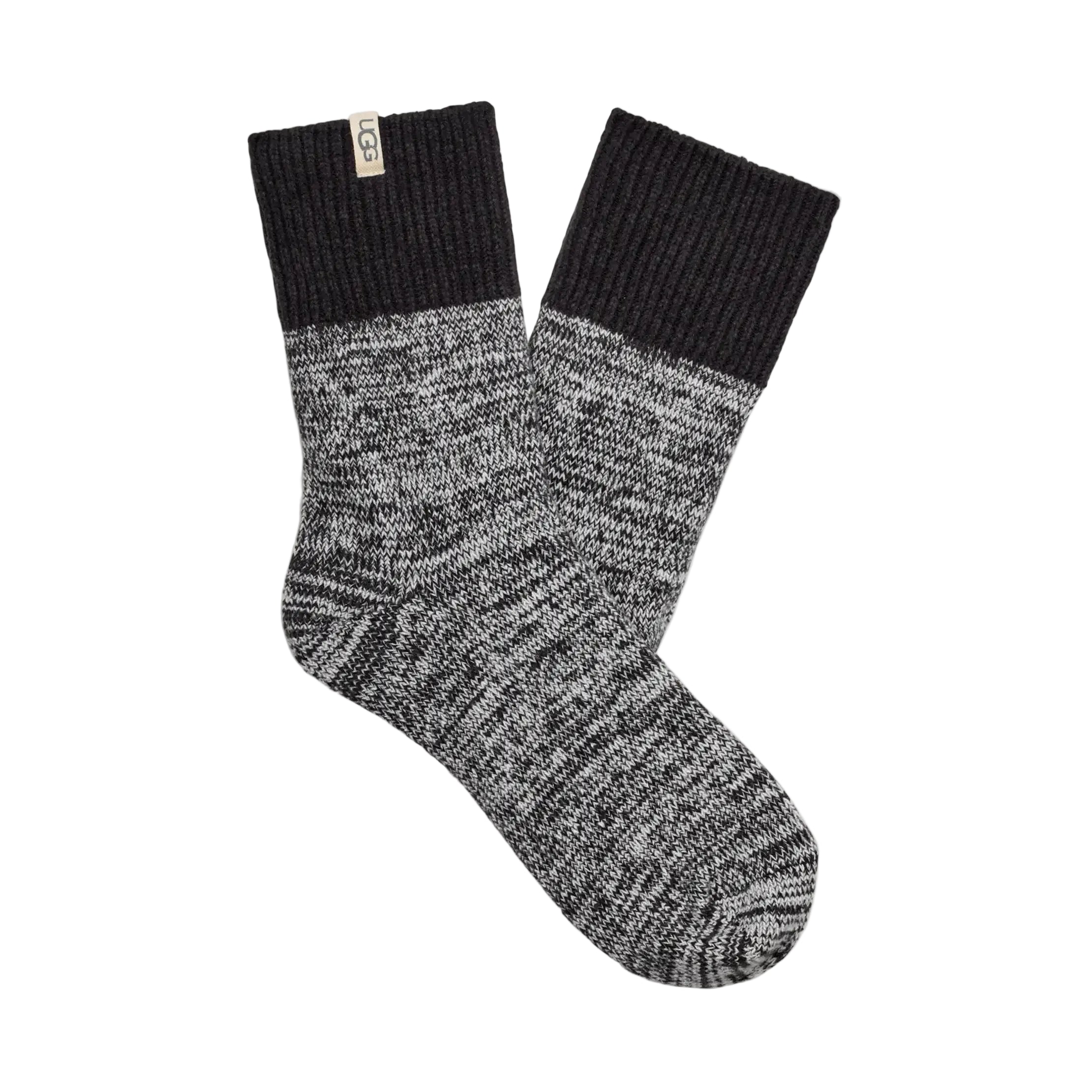 A pair of UGG rib knit slouchy quarter socks with a black ribbed cuff and a black-and-white heathered knit body, displayed on a white background. Available at Be Charmed