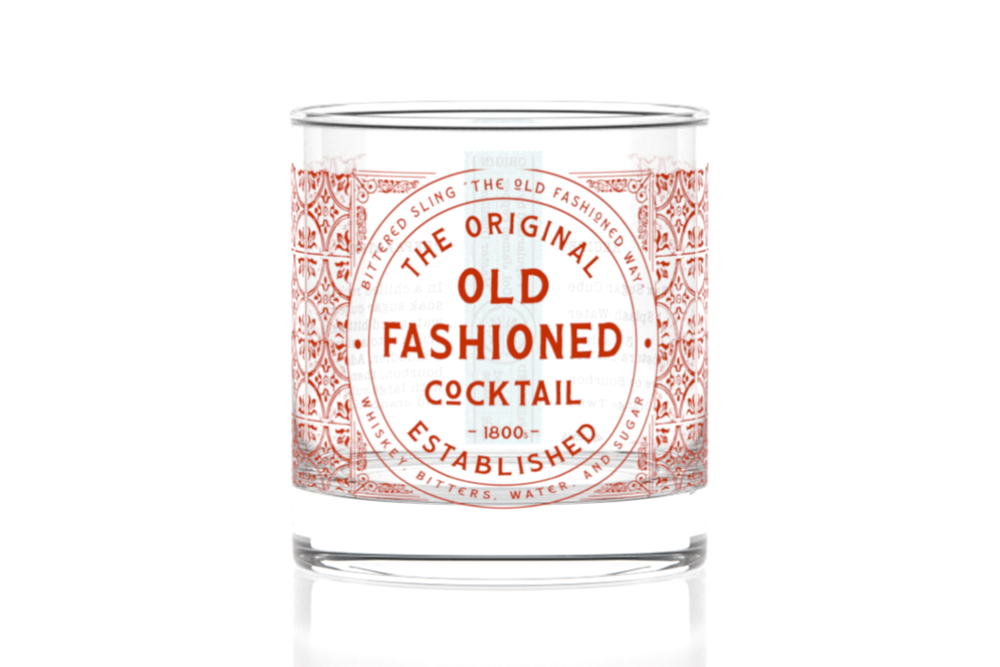 Cocktail glass with 'The Original Old Fashioned Cocktail' label on a white background. Available at Be Charmed