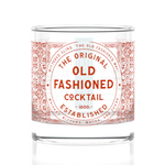 Cocktail glass with 'The Original Old Fashioned Cocktail' label on a white background. Available at Be Charmed
