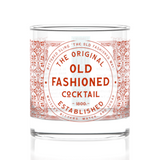 Cocktail glass with 'The Original Old Fashioned Cocktail' label on a white background. Available at Be Charmed